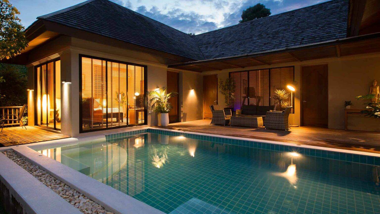 Our Rooms - Bedroom with pool at night